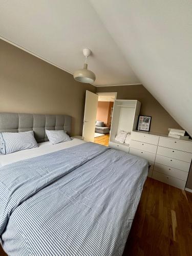 a bedroom with a large bed in a attic at Villa Nina in Sävsjö