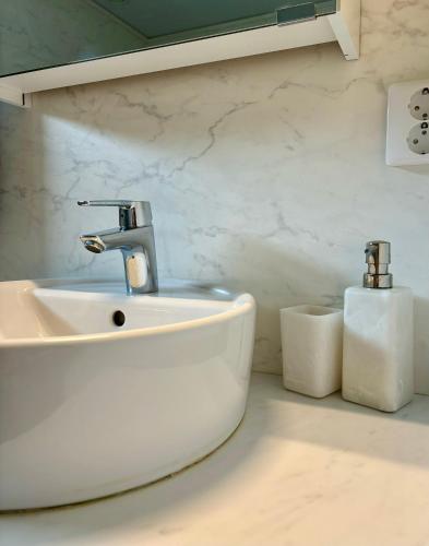 a bathroom with a sink and two rolls of toilet paper at Villa Nina in Sävsjö