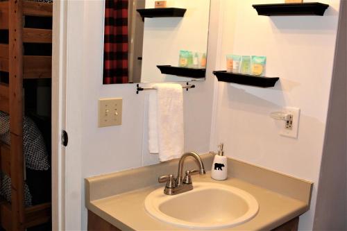a bathroom with a sink and a mirror at Bear Canyon Condo #129 in Ruidoso