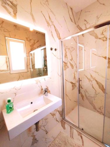 a bathroom with a sink and a shower at Spirit of Gozo unique penthouse in Xagħra