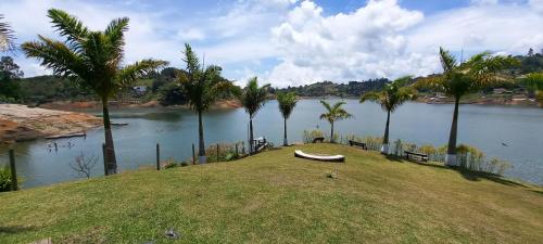 a boat sitting on top of a hill next to a river at Jordan Hotel Boutique in Guatapé