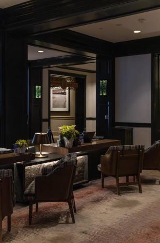 a meeting room with chairs and a projection screen at Ascent 203 by East West Hospitality in Avon