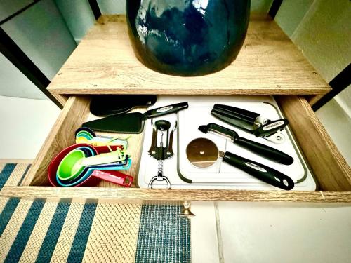 a wooden drawer filled with kitchen utensils at Casa Playa in Boqueron