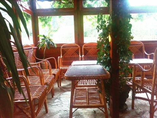 a table and chairs in a room with a window at Zodiac House in Samokov