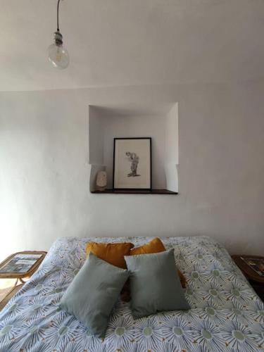 a bedroom with a bed with two pillows on it at Mozzafiato Casa Collina in Conzano