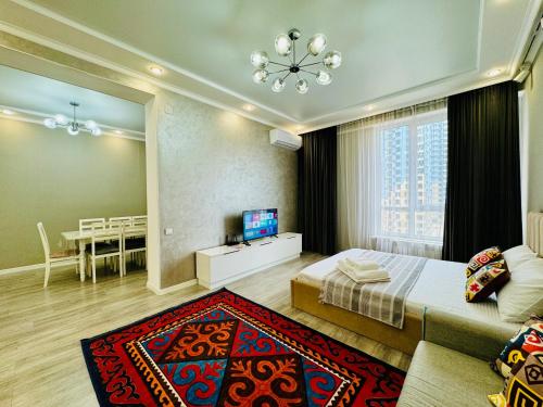 a bedroom with a bed and a dining room at Ethnic in Almaty