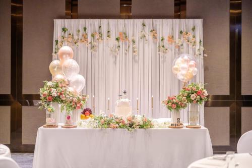 a table with balloons and a cake on top of it at Courtyard by Marriott Seoul Namdaemun in Seoul