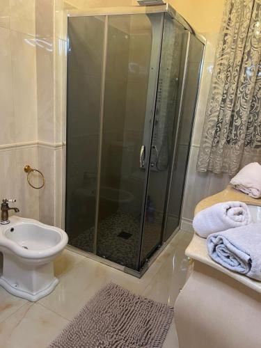a bathroom with a shower and a toilet and a sink at B & B Temptation Airport Fontanarossa shared house with several rooms in Catania
