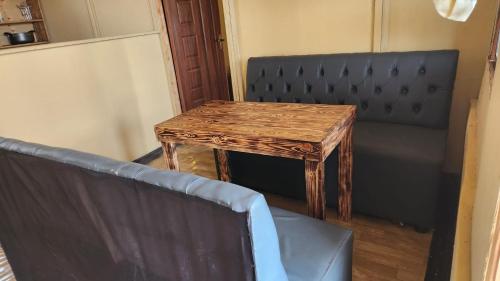 a wooden table and a chair in a room at Amanya 2 Bedroom Self Catering Tent in Amboseli