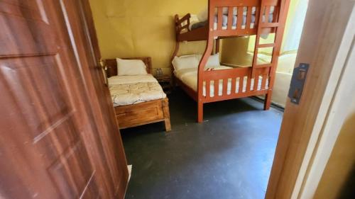 a small room with two bunk beds and a bed at Amanya 2 Bedroom Self Catering Tent in Amboseli