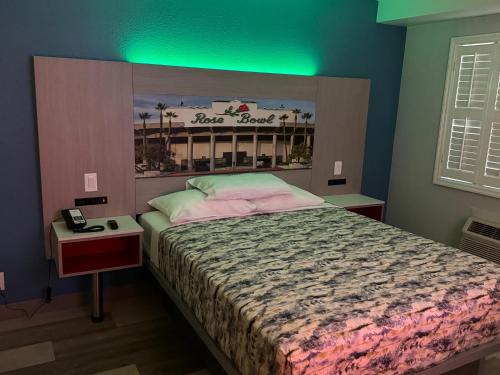 a bedroom with a bed with a sign on the wall at Lincoln Motel - Los Angeles, Hollywood Area in Pasadena