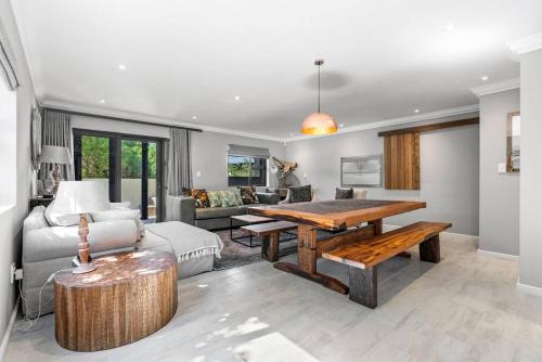 a living room with a table and a couch at Flamingo Bay Manor in Fisherhaven