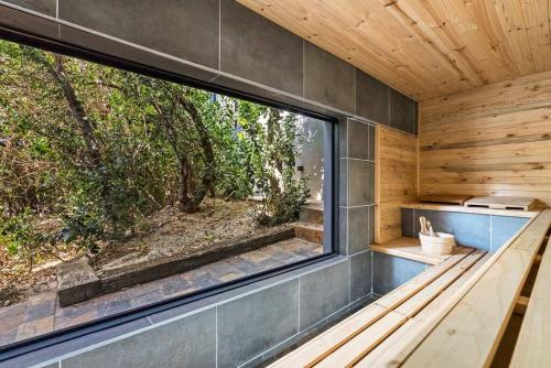 a room with a large window and a bench at Flamingo Bay Manor in Fisherhaven