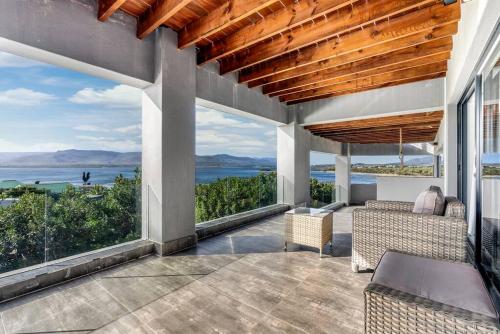 an outdoor patio with a view of the ocean at Flamingo Bay Manor in Fisherhaven