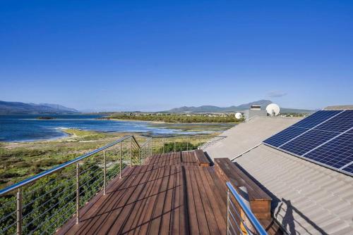 a roof with solar panels and a body of water at Flamingo Bay Manor in Fisherhaven