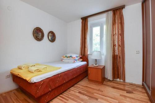 a bedroom with a bed and a window at Seaside holiday house Zaton Veliki, Dubrovnik - 23195 in Zaton