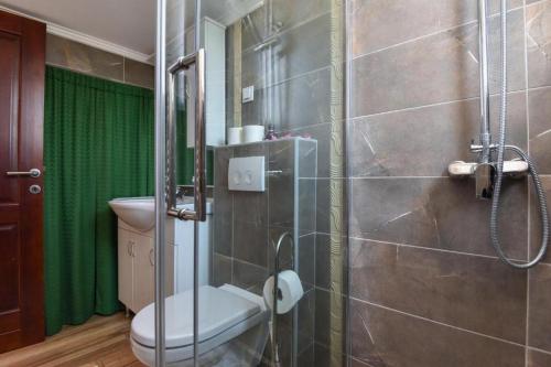 a bathroom with a toilet and a glass shower at Seaside holiday house Zaton Veliki, Dubrovnik - 23195 in Zaton