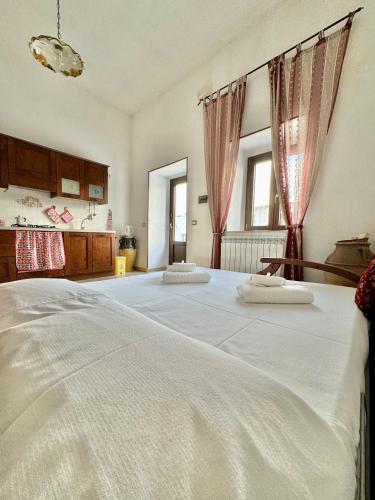 a bedroom with a large bed with two pillows on it at Villa La Rosa in Chiaramonte Gulfi