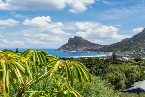 a view of a beach with mountains and the ocean at SunsetViews Houtbay in Hout Bay
