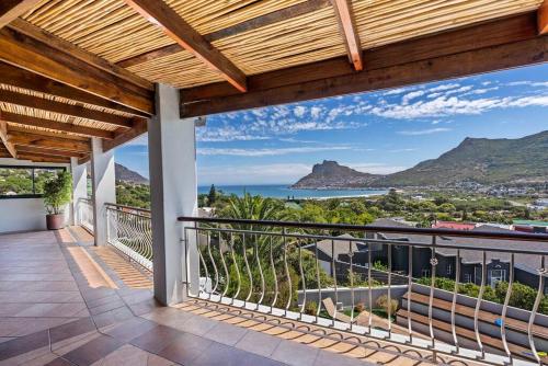 a balcony with a view of the ocean and mountains at SunsetViews Houtbay in Hout Bay