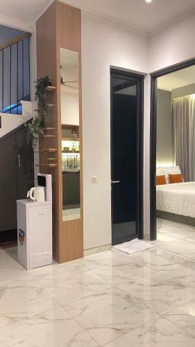 a room with a room with a bed and a door at Pinasti Nirwana Villas in Batu