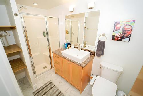 a bathroom with a toilet and a sink and a shower at Illuminati Guest House in Victoria