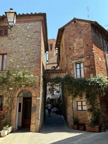 an alley in an old stone building with an archway at 2 King Bed, 2 Full Bathroom Apartment in Umbria - Tuscany in Città della Pieve