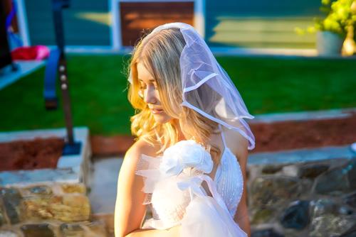 a woman in a wedding dress with a veil at Illuminati Guest House in Victoria