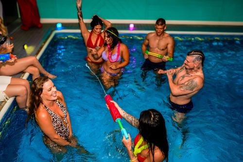 a group of people in a swimming pool at Illuminati Guest House in Victoria