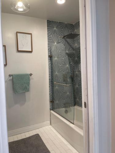 a bathroom with a shower with a glass door at Studio Stay in West Covina