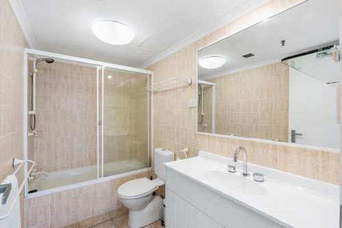 a bathroom with a toilet and a sink and a shower at Stunning Beach & Ocean Views in Gold Coast