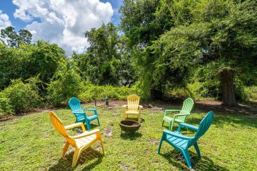 a group of chairs sitting in the grass at Casa Dell'Amore in Murdock