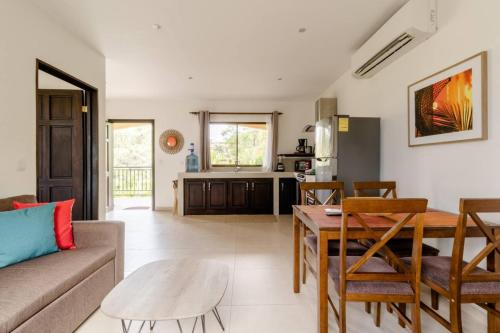 a living room with a couch and a table at Green Villas Tamarindo in Tamarindo