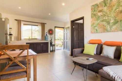 a living room with a couch and a table at Green Villas Tamarindo in Tamarindo