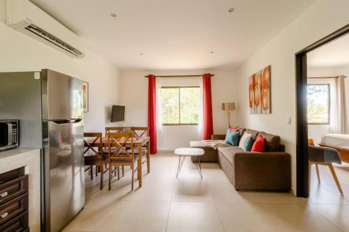 a kitchen and living room with a couch and a table at Green Villas Tamarindo in Tamarindo
