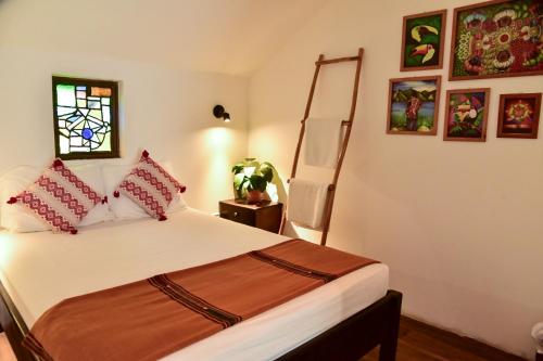 a bedroom with a bed and a window at Los Amigos Hostel in Flores