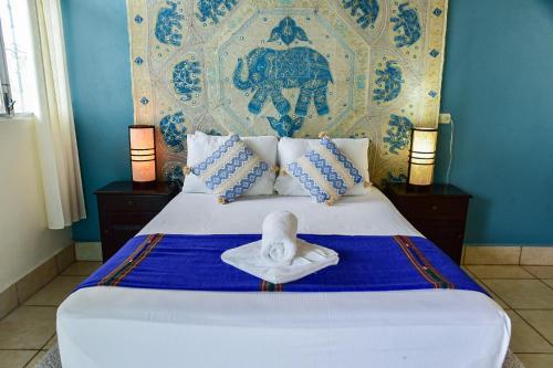 a bed with a swan sitting on top of it at Los Amigos Hostel in Flores