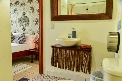 a bathroom with a sink and a mirror at Los Amigos Hostel in Flores