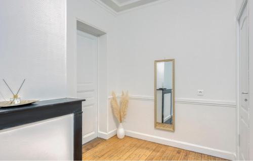 a mirror in a white room with a wooden floor at ZACH & SPA - Maison jardin à 20 min de Paris & Aéroport CDG in Livry-Gargan