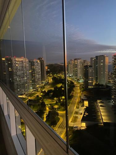 a view of a city at night from a building at Costa de Montemar in Concón