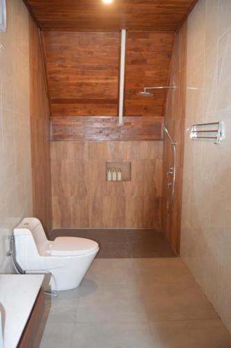 a bathroom with a toilet and a shower at Svargan Lakeside Glamping in Tabanan