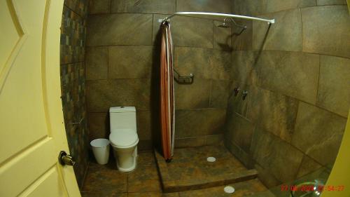 a small bathroom with a shower and a toilet at Hotel San Antonio Guanajuato in Guanajuato