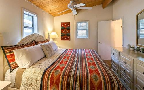 a bedroom with a bed and a ceiling fan at Mama Bears Cabin in Ruidoso
