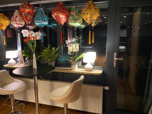a room with a table and chairs and colorful lights at 1 grosse elegante Zimmerwohnung 5 Minuten zu Fuss in die Stadtmitte in Lörrach