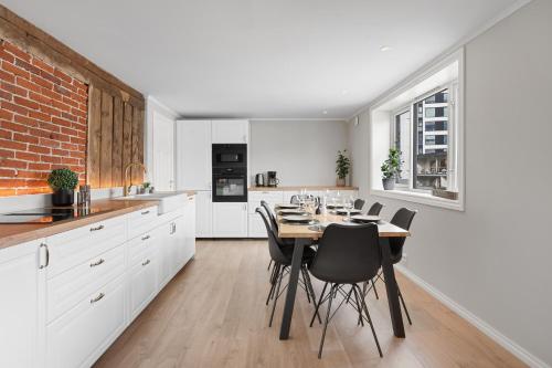 a kitchen and dining room with a table and chairs at Arctic Homes - ALL APARTMENTS in Tromsø