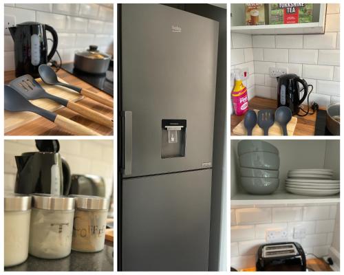 a refrigerator in a kitchen with plates and utensils at Luton Airport House, Opposite airport staff parking in Luton