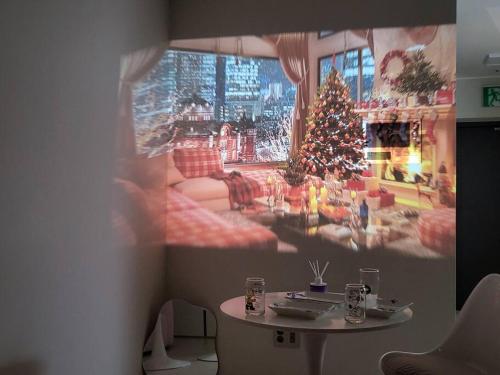 a wall with a picture of a living room with a christmas tree at Geumjeong St1 Minute Seoul, Gangnam Transportation NICE in Gunpo