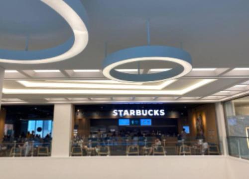 a shopping mall with a starbucks sign on the ceiling at Geumjeong St1 Minute Seoul, Gangnam Transportation NICE in Gunpo