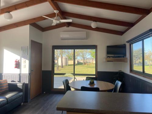 a living room with a table and a window at Kerang Holiday park in Kerang