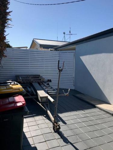 a scooter parked on a patio next to a garage at St Helens Beachfront in Edithburgh